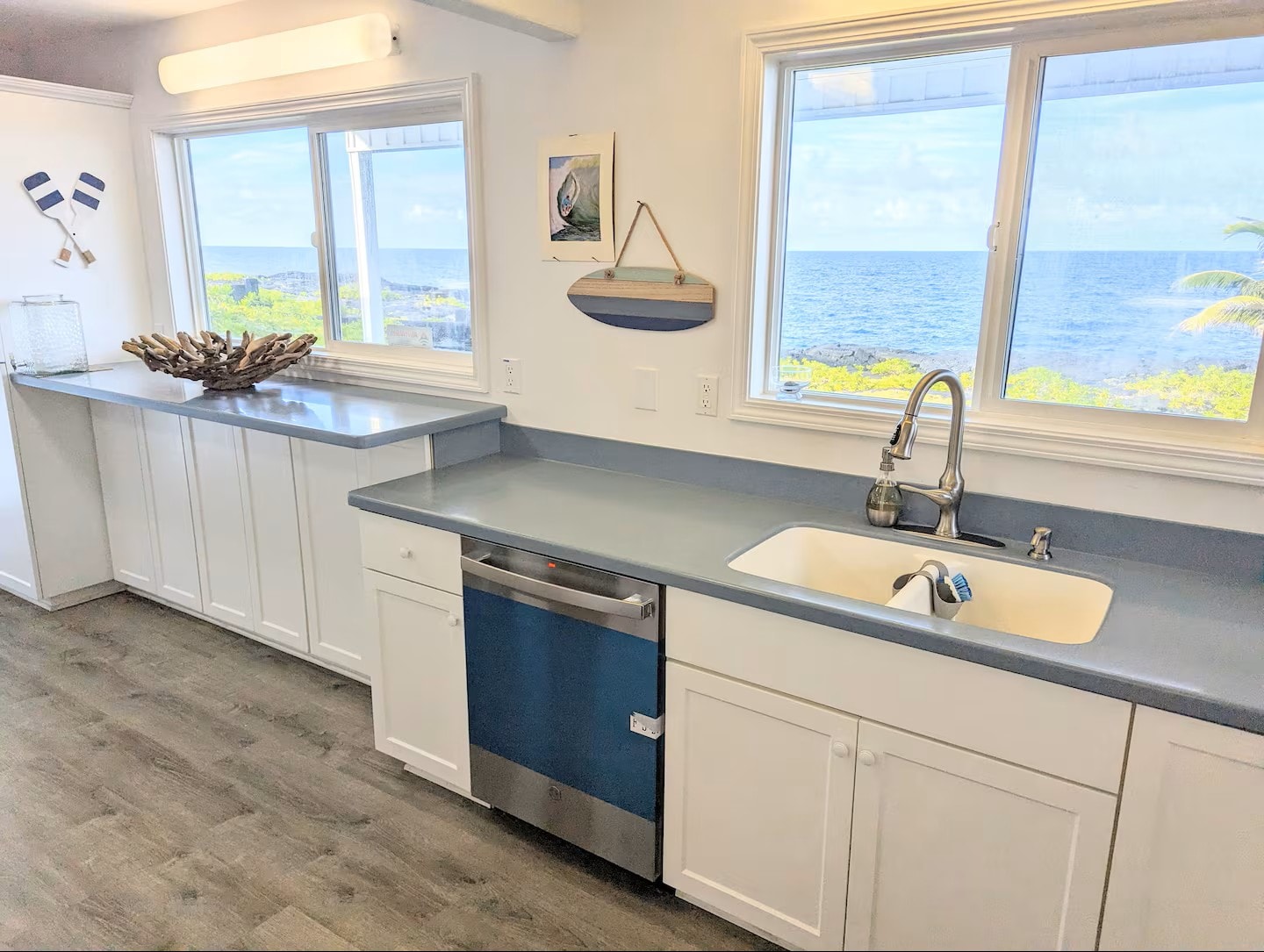 Kitchen with white cabinetry, blue countertops, and panoramic ocean views